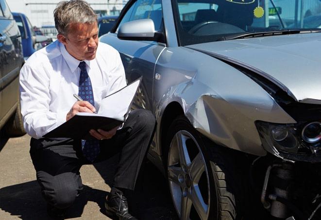 auto insurance policy documents and a smartphone